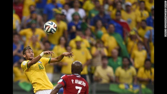 Brazilian forward Neymar heads the ball past Colombian defender Pablo Armero. 