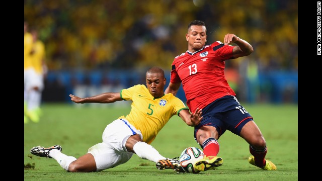 Fernandinho of Brazil, left, tackles Fredy Guarin of Colombia. 