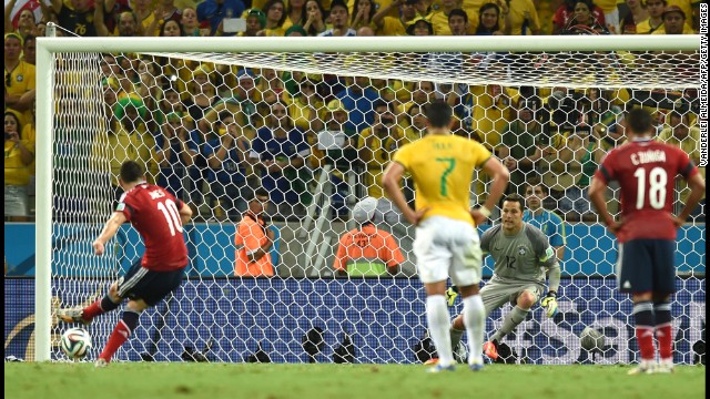 Colombia midfielder James Rodriguez, left, shoots and scores a penalty. 