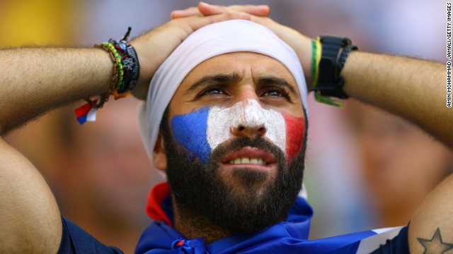 A France fan at the stadium in Rio de Janeiro reacts after the match against Germany.