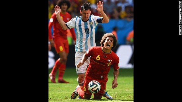 Argentina's Messi challenges Axel Witsel of Belgium.