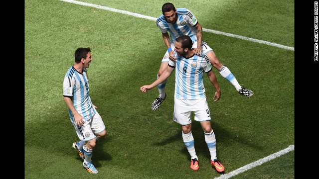 Argentina forward Gonzalo Higuain, right, celebrates with di Maria, top, and Messi, left, after scoring.