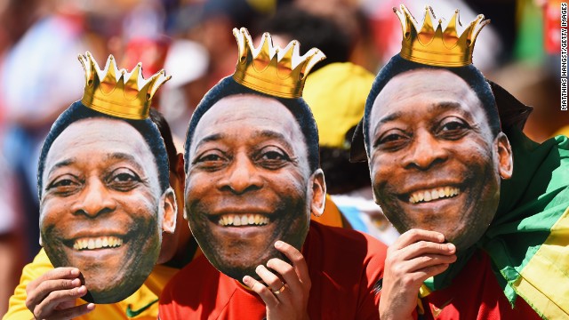 Fans hold up cutouts of Brazilian legend Pele prior to the match between Argentina and Belgium.