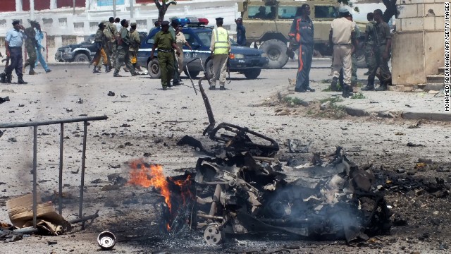 The remains of a car bomb burn on July 5, 2014 after it exploded outside the Somali parliament building in Mogadishu.