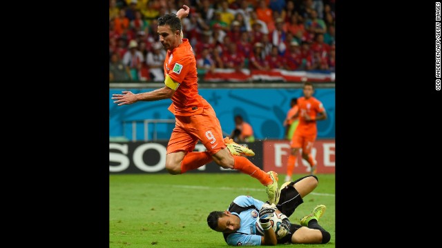 Netherlands forward and captain Robin van Persie, left, fails to score past Costa Rica goalkeeper Keylor Navas. 