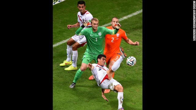Johnny Acosta of Costa Rica attempts a shot on goal against goalkeeper Jasper Cillessen and Ron Vlaar of the Netherlands. 