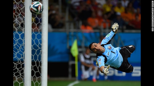 Costa Rica goalkeeper Keylor Navas dives for the ball. 