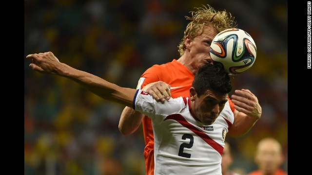 Costa Rica defender Johnny Acosta (front) vies with Netherlands' forward Dirk Kuyt. 