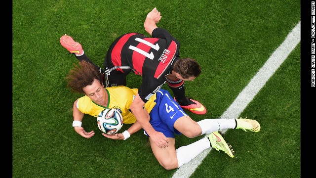 Klose and David Luiz compete for the ball.