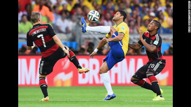 Hulk shields the ball from Schweinsteiger and German defender Jerome Boateng.