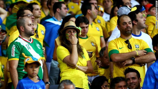 Brazil fans look dejected at the stadium.