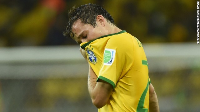 Brazil's Bernard wipes his face during the match.