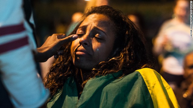 A fan wipes another fan's tears in the streets of Sao Paulo, Brazil.