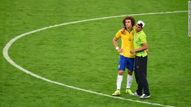 Brazil's Thiago Silva, right, consoles teammate David Luiz after the match. Silva, Brazil's captain, had been suspended and couldn't play.