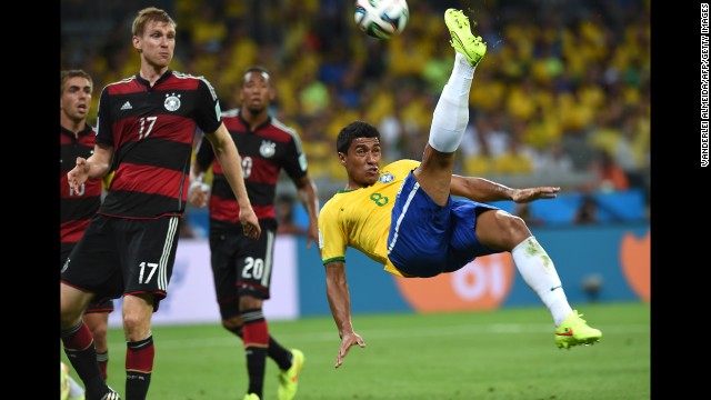 Brazilian midfielder Paulinho attempts an overhead kick.
