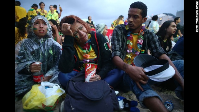 Brazil fans are devastated while watching the first half on Copacabana beach in Rio de Janeiro.