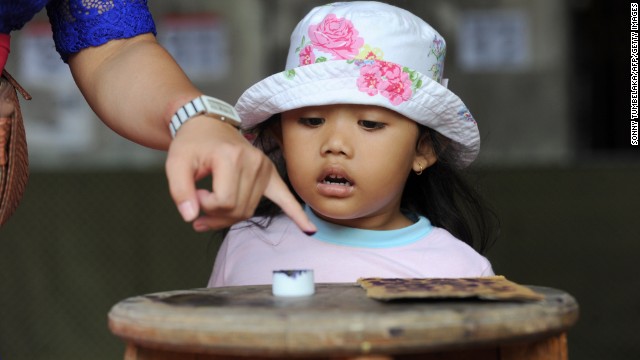 A Balinese woman inks her finger after voting in the presidential election in Bali on July 9.