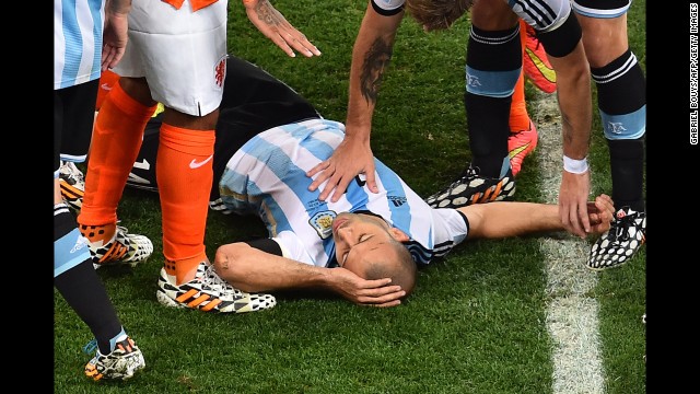 Argentina midfielder Javier Mascherano receives medical assistance. His head collided with an opponent's in the first half, but he kept playing.