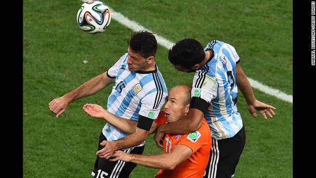 Robben, center, heads the ball next to Argentina defenders Martin Demichelis, left, and Ezequiel Garay.