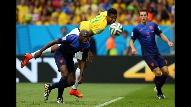 Jo of Brazil and Bruno Martins Indi of the Netherlands compete for the ball.