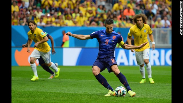Robin van Persie of the Netherlands shoots and scores the first goal of the third-place match.