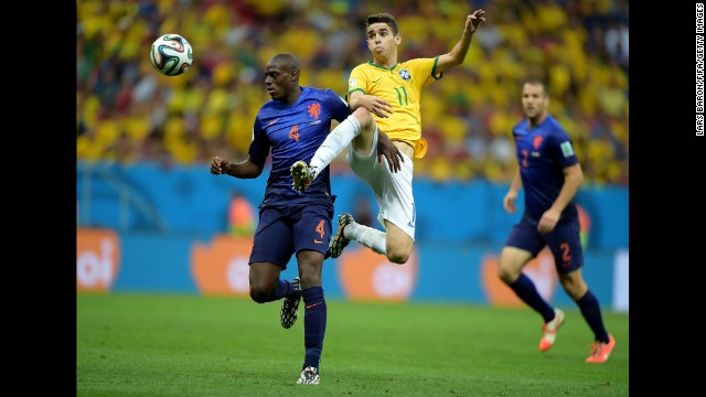 Oscar of Brazil and Bruno Martins Indi of the Netherlands compete for the ball. 