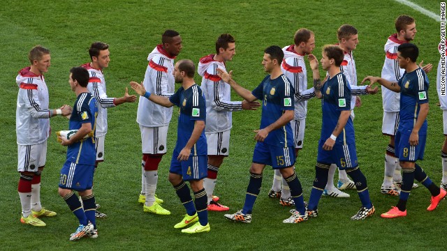 The two teams shake hands before kickoff.