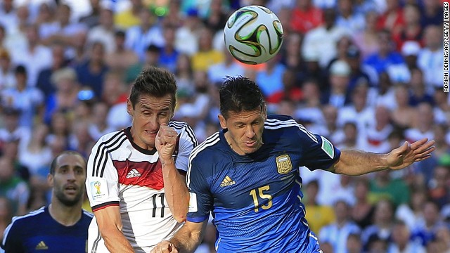 Klose, left, goes up for a header with Argentine defender Martin Demichelis.