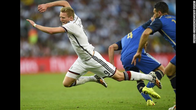 Germany's Andre Schurrle falls to the ground after a challenge from Zabaleta, center.