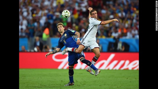 Biglia, left, and Germany's Philipp Lahm go up for a header.