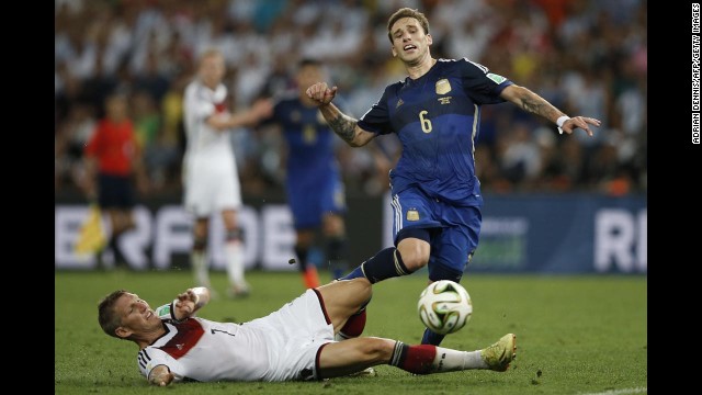 Schweinsteiger slides to tackle Argentina's Lucas Biglia.