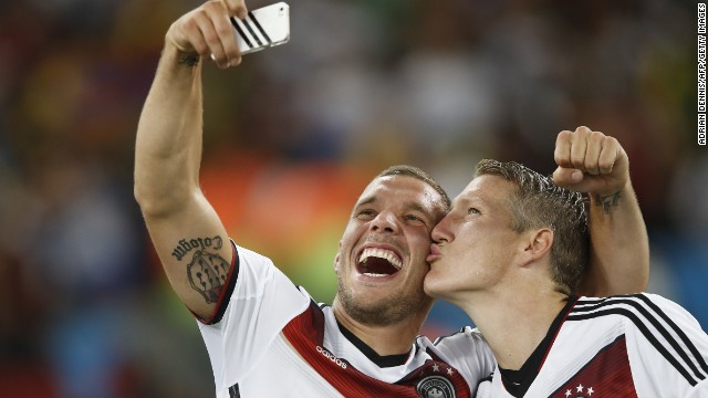 Germany's Lukas Podolski, left, takes a selfie with teammate Bastian Schweinsteiger after the match.