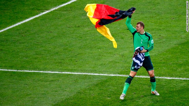 Goalkeeper Manuel Neuer celebrates with a German flag after the match.