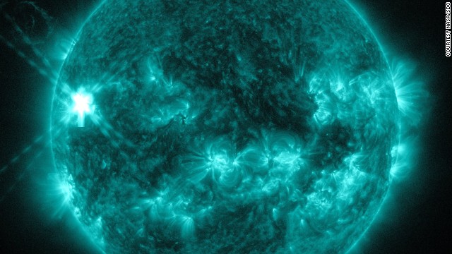 A mid-level flare erupted on the left side of the sun on July 8, 2014. This image from NASA's Solar Dynamics Observatory highlights the high-temperature solar material in a flare, which is typically colorized in teal. 