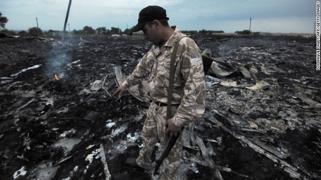 A man inspects debris from the plane.