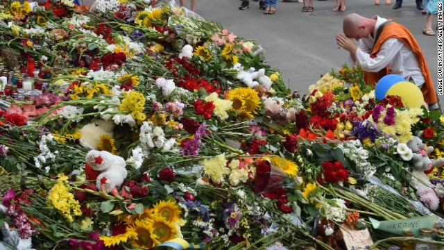A man prays at a memorial in front of the Dutch Embassy in Kiev on July 18.