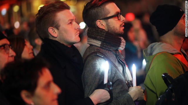 People in Melbourne gather to mourn the victims during a candlelight vigil at Federation Square on July 22.