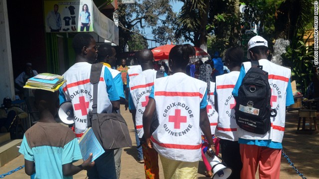 People can be infected by others if they come into contact with body fluids from an infected person or contaminated objects from infected persons. Pictured, Guinean Red Cross members spread awareness about the Ebola virus.