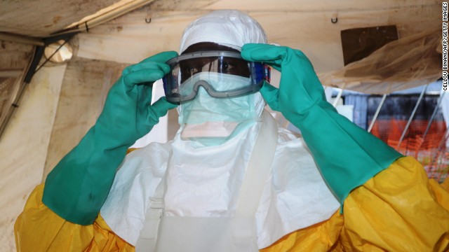 A member of Doctors Without Borders puts on protective gear at the isolation ward of the Donka Hospital in Conakry on Saturday, June 28.