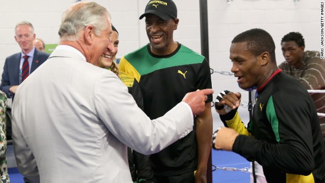 Prince Charles does some mock sparring with a member of the Jamaican boxing team at the 2014 Commonwealth Games. 