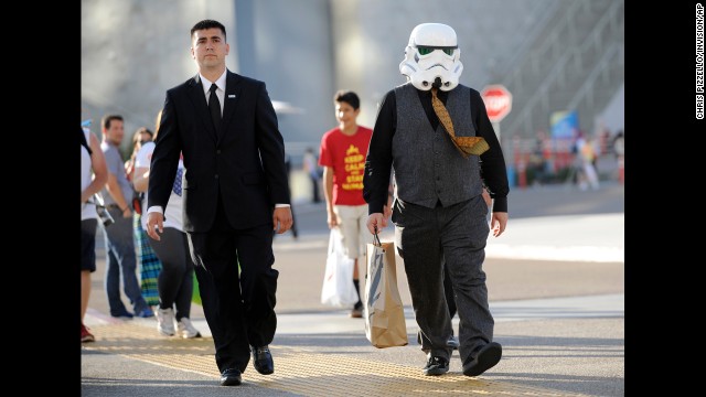 Actor Jack Black, wearing a Star Wars Stormtrooper mask, right, walks outside the convention center on on Thursday, July 24, in San Diego. 