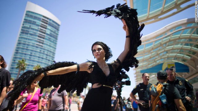 A woman dressed as the character Katniss Everdeen from the movie "The Hunger Games: Catching Fire" poses in front of Comic-Con on July 24. 