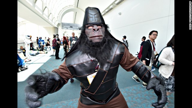 A fan dressed as a character from "Planet of the Apes" walks inside the convention center on July 26. 