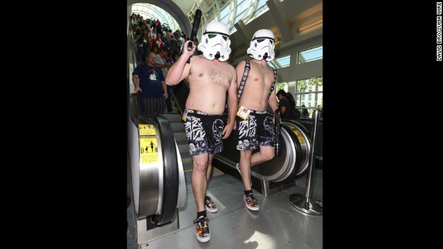 Two shirtless stormtroopers patrol the convention hall.