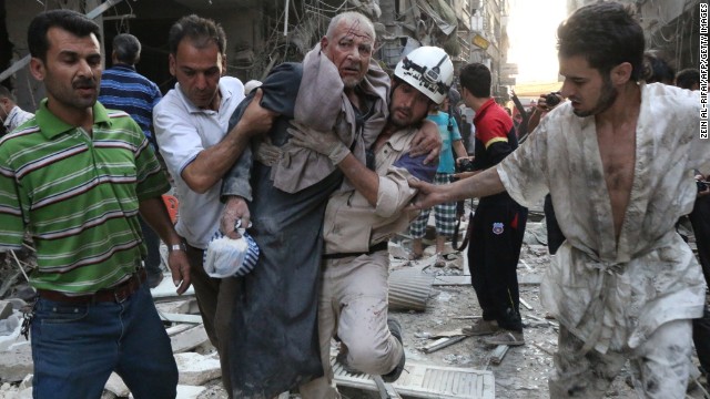 People carry an injured man away from the site of an airstrike, reportedly carried out by Syrian government forces, in Aleppo, Syria, on Sunday, July 27. The United Nations estimates more than 100,000 people have been killed in Syria since an uprising in March 2011 spiraled into civil war.