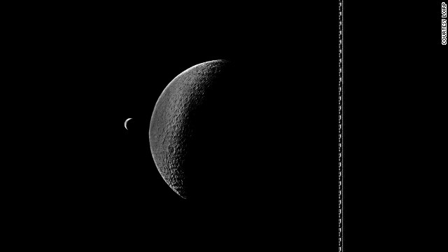 Lunar Orbiter 4 photograph showing a crescent Earth and partly illuminated Moon.
