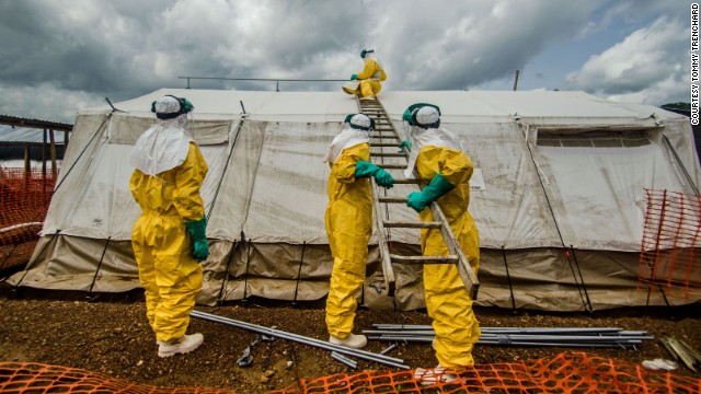 Members of Doctors Without Borders adjust tents in the isolation area in Kailahun on July 20.