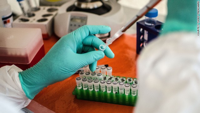 A doctor works in the field laboratory at the Ebola treatment center in Kailahun on Thursday, July 17.