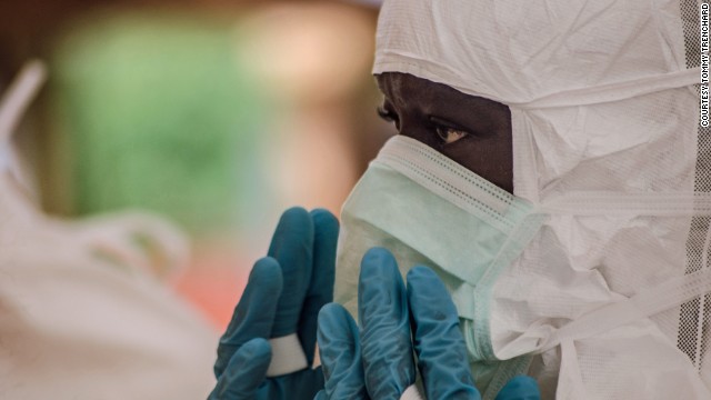 A doctor puts on protective gear at the treatment center in Kailahun on Sunday, July 20.