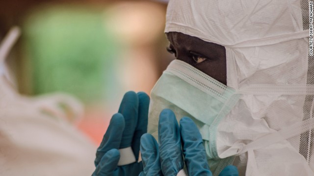 A doctor puts on protective gear at the treatment center in Kailahun, Sierra Leone, on Sunday, July 20.